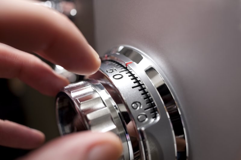 Hand opening an office or home safe, by operating the locking dial.